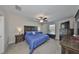 This main bedroom features neutral walls, carpeted floor, a ceiling fan, and ample furnishings at 16665 Delia St, Wimauma, FL 33598