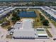 Aerial view of community with pool, shuffleboard court, pond, and multi-story buildings at 1950 59Th N Ave # 208, St Petersburg, FL 33714