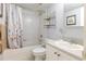 Clean bathroom with a floral shower curtain, white tiled walls, and standard fixtures at 1950 59Th N Ave # 208, St Petersburg, FL 33714