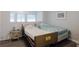 Simple bedroom with two beds, modest furnishings, and natural lighting from the window at 1950 59Th N Ave # 208, St Petersburg, FL 33714