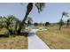 Scenic view of a community park with a lake, picnic tables, and lush landscaping on a sunny day at 1950 59Th N Ave # 208, St Petersburg, FL 33714