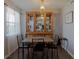 Well-lit dining room with a modern table set, elegant lighting, and neutral wall color at 1950 59Th N Ave # 208, St Petersburg, FL 33714