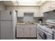 Efficient kitchen featuring white appliances, ample cabinet space, and neutral countertops at 1950 59Th N Ave # 208, St Petersburg, FL 33714