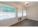 Bright living room featuring wood-look floors, fresh white walls, a ceiling fan, and natural light from large windows at 1950 59Th N Ave # 208, St Petersburg, FL 33714