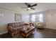 Comfortable living room with wood-look floors, ceiling fan, and plenty of seating at 1950 59Th N Ave # 208, St Petersburg, FL 33714