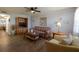 Comfortable living room with wood-look floors, ceiling fan, and a flat screen TV at 1950 59Th N Ave # 208, St Petersburg, FL 33714