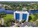 Aerial view of condo with tennis court, parking, and landscaping at 2780 N Riverside Dr # 802, Tampa, FL 33602