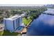 An aerial view showcases the apartment complex and community amenities of a pool, dock, and tennis court at 2780 N Riverside Dr # 802, Tampa, FL 33602