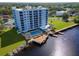 Aerial view of waterfront condo featuring a pool and dock overlooking the serene waterfront at 2780 N Riverside Dr # 802, Tampa, FL 33602