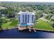 Stunning aerial view of a waterfront condo featuring a pool, dock, and lush green landscaping at 2780 N Riverside Dr # 802, Tampa, FL 33602