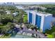 An aerial view of a waterfront apartment complex surrounded by lush greenery and parking spaces at 2780 N Riverside Dr # 802, Tampa, FL 33602