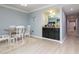 Charming dining area featuring a stylish bar area with granite counter and light wood plank floors at 2780 N Riverside Dr # 802, Tampa, FL 33602