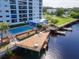 Picturesque wooden dock featuring tables and chairs and access to waterfront at 2780 N Riverside Dr # 802, Tampa, FL 33602