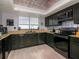 Stylish kitchen featuring black cabinetry, granite countertops, and stainless steel appliances at 2780 N Riverside Dr # 802, Tampa, FL 33602
