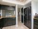 Efficient kitchen with black appliances, granite countertops, and a view into the dining area at 2780 N Riverside Dr # 802, Tampa, FL 33602