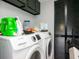 Functional laundry room with modern washer and dryer, plus overhead storage at 2780 N Riverside Dr # 802, Tampa, FL 33602