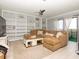 Spacious living room with custom built-ins, a comfy sectional, and balcony access, creating a cozy inviting space at 2780 N Riverside Dr # 802, Tampa, FL 33602