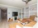 Comfortable living room with built-in shelving, a large sectional sofa, and a view into the hallway at 2780 N Riverside Dr # 802, Tampa, FL 33602