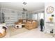 Bright living room featuring custom built-in shelving, comfortable sectional sofa, and access to a balcony at 2780 N Riverside Dr # 802, Tampa, FL 33602