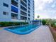 Community pool area with brick pavers, sun loungers, and shade trees at this apartment complex at 2780 N Riverside Dr # 802, Tampa, FL 33602