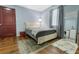 Comfortable bedroom featuring a plush bed, light blue walls, and hardwood floors at 3212 E Henry Ave, Tampa, FL 33610