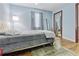 Comfortable bedroom showcasing a plush bed, light blue walls, and hardwood floors at 3212 E Henry Ave, Tampa, FL 33610
