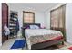 Bedroom featuring two windows with dark curtains, and hardwood-look floors at 3212 E Henry Ave, Tampa, FL 33610