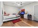 Cozy bedroom features a ceiling fan, wood floors, and a desk for a comfortable living space at 3212 E Henry Ave, Tampa, FL 33610