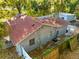 Aerial view of the home, showcasing backyard fencing, lush greenery, and a storage shed at 3212 E Henry Ave, Tampa, FL 33610