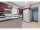 Functional kitchen featuring granite countertops, white appliances, and tile flooring at 3212 E Henry Ave, Tampa, FL 33610