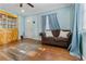 Cozy living room featuring wood floors, with a 2 seat couch and a wood display case at 3212 E Henry Ave, Tampa, FL 33610