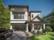 Striking modern home with a glass garage door, covered porch, and meticulous landscaping at 3406 W Arch St, Tampa, FL 33607