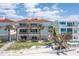 Beautiful beachfront home with balconies overlooking white sand and blue water, with palm trees at 36 Gulf Blvd # 3, Indian Rocks Beach, FL 33785