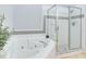 A well-maintained bathroom features a large soaking tub and glass-enclosed shower at 36 Gulf Blvd # 3, Indian Rocks Beach, FL 33785