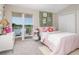 Cheerful bedroom features a slider to the balcony, pink accents, and a light, beachy vibe at 36 Gulf Blvd # 3, Indian Rocks Beach, FL 33785