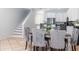 Chic dining area with seating for six, staircase, and easy access to the kitchen at 36 Gulf Blvd # 3, Indian Rocks Beach, FL 33785