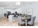 Open dining area with counter seating, a table for six and stylish gray upholstered chairs at 36 Gulf Blvd # 3, Indian Rocks Beach, FL 33785