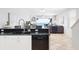 Modern kitchen with stainless steel appliances and granite countertops, with open-concept to living room at 36 Gulf Blvd # 3, Indian Rocks Beach, FL 33785