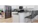 Stylish kitchen with stainless steel appliances, black countertops and bar stool seating at 36 Gulf Blvd # 3, Indian Rocks Beach, FL 33785