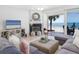 Comfortable living room with fireplace and sliding doors to balcony with ocean view at 36 Gulf Blvd # 3, Indian Rocks Beach, FL 33785