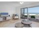 Bright living room with tile floors, ceiling fan, and sliding glass doors to the patio, offering stunning beach views at 36 Gulf Blvd # 3, Indian Rocks Beach, FL 33785