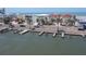 Nice waterfront featuring private docks lining a scenic coastal street enhanced by palm trees at 36 Gulf Blvd # 3, Indian Rocks Beach, FL 33785