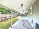 Backyard with covered porch, fence and in-ground pool at 3702 W Reynolds St, Plant City, FL 33563