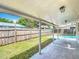 Backyard with covered porch, fence and in-ground pool at 3702 W Reynolds St, Plant City, FL 33563