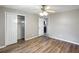 Bedroom features hardwood floors, ceiling fan with lighting, and closet at 3702 W Reynolds St, Plant City, FL 33563