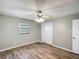 Bedroom features hardwood floors, ceiling fan with lighting, window and closet at 3702 W Reynolds St, Plant City, FL 33563