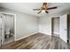 Bedroom with hard surface floors, a ceiling fan, walk-in closet and an en-suite bathroom at 3702 W Reynolds St, Plant City, FL 33563