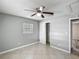 Bedroom features tile floors, ceiling fan with lighting, window and closet at 3702 W Reynolds St, Plant City, FL 33563