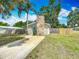 Charming single-story home with a stone chimney, blue door and a well-maintained lawn at 3702 W Reynolds St, Plant City, FL 33563