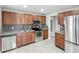 Well-equipped kitchen featuring stainless steel appliances, granite countertops and wood cabinets at 3702 W Reynolds St, Plant City, FL 33563